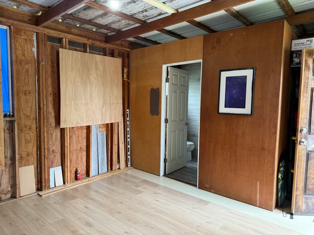 a view of hallway with wooden floor