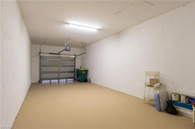 an empty room with furniture and a projector