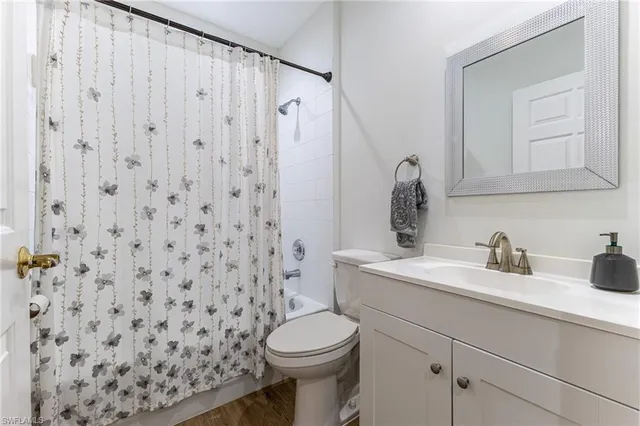 a bathroom with a sink toilet and mirror