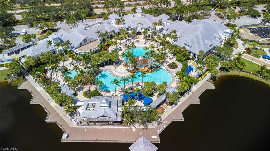 3975 Deer Crossing Court, Unit 102 Naples, FL 34114 - Photo 2 of 32 an aerial view of residential houses with outdoor space