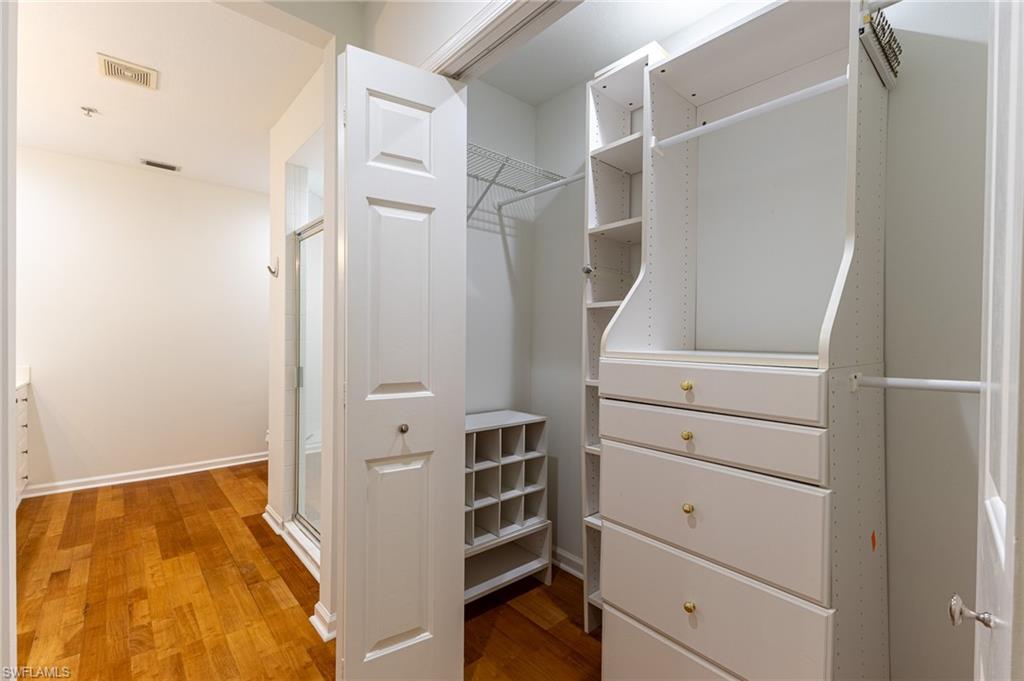 3975 Deer Crossing Court, Unit 102 Naples, FL 34114 - Photo 21 of 32 a view of walk in closet with empty racks