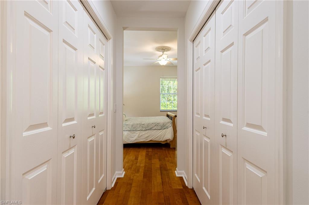 3975 Deer Crossing Court, Unit 102 Naples, FL 34114 - Photo 25 of 32 a view of a bedroom with wooden floor and balcony