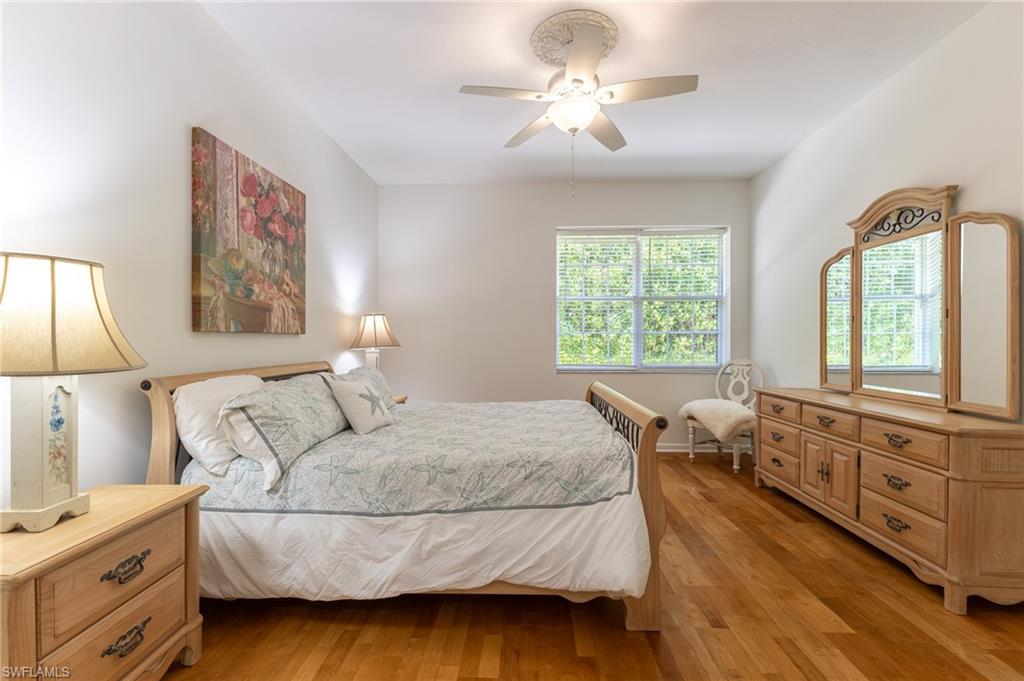 3975 Deer Crossing Court, Unit 102 Naples, FL 34114 - Photo 26 of 32 a bedroom with a large bed and a window