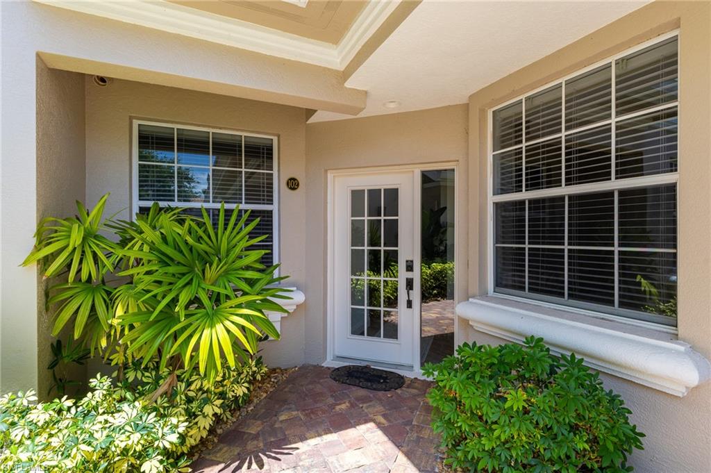 3975 Deer Crossing Court, Unit 102 Naples, FL 34114 - Photo 8 of 32 a view of front door with potted plant in front of house