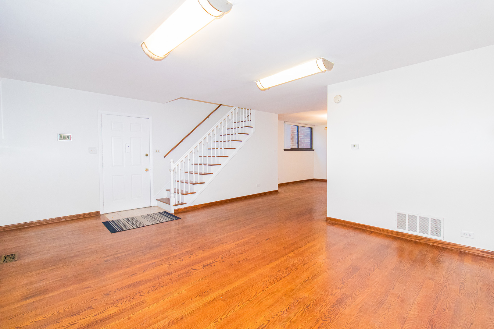 902 South May Street, Unit D Chicago, IL 60607 - Photo 6 of 24 a view of an empty room with stairs and a window