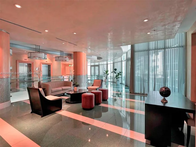 a lobby with furniture and lots of tables