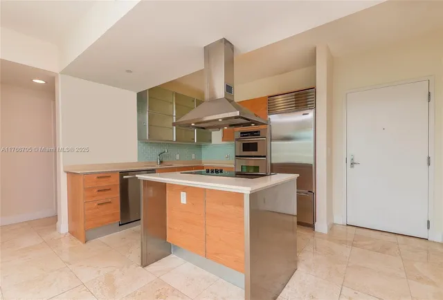 a kitchen with a stove top oven and cabinets