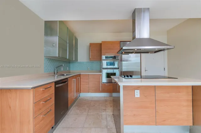 a kitchen with stainless steel appliances granite countertop a sink and a stove