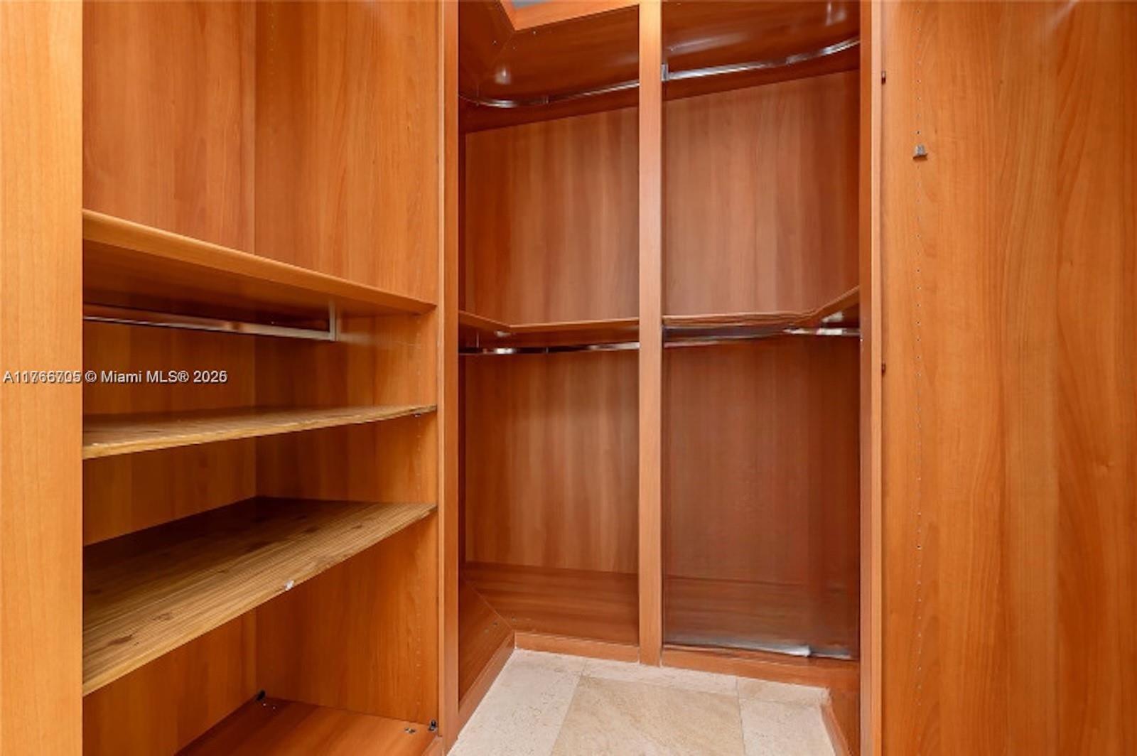 218 Southeast 14th Street, Unit 1203 Miami, FL 33131 - Photo 9 of 22 a view of walk in closet with empty racks