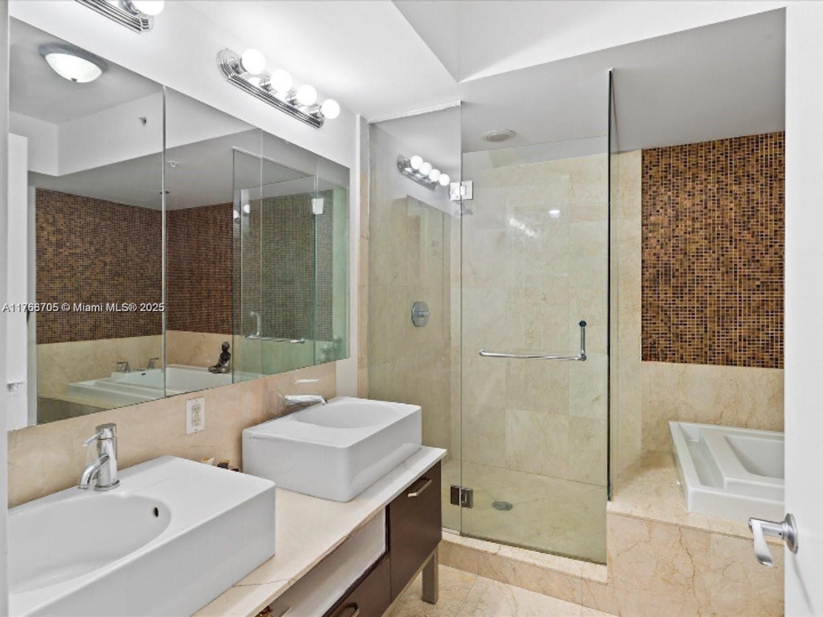 218 Southeast 14th Street, Unit 1203 Miami, FL 33131 - Photo 10 of 22 a bathroom with a tub sink shower and mirror
