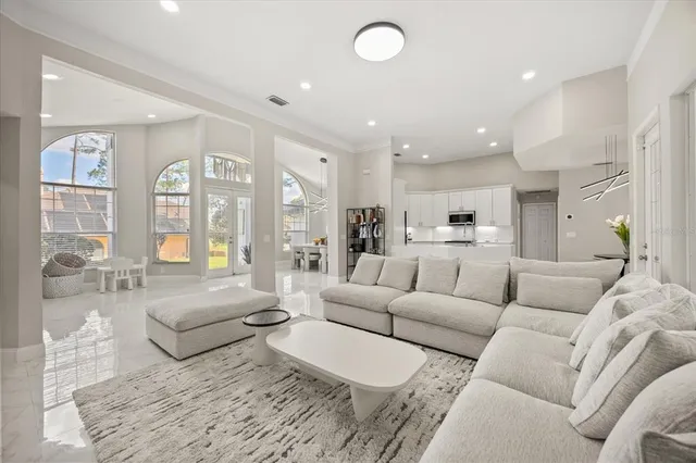 a living room with furniture white walls and wooden floor