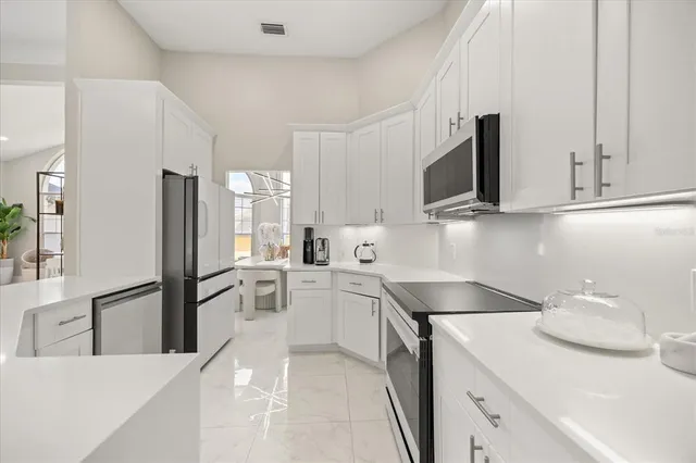 a kitchen with a sink microwave and refrigerator