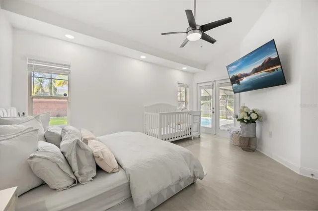 a bedroom with a bed and a chandelier