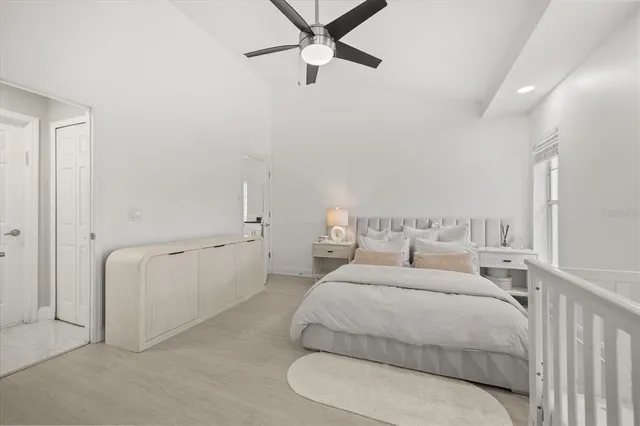 a bed room with a bed and a ceiling fan