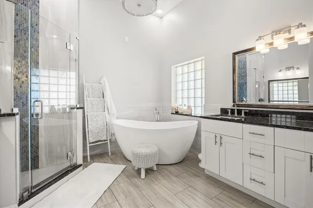 a bathroom with a bathtub and a sink