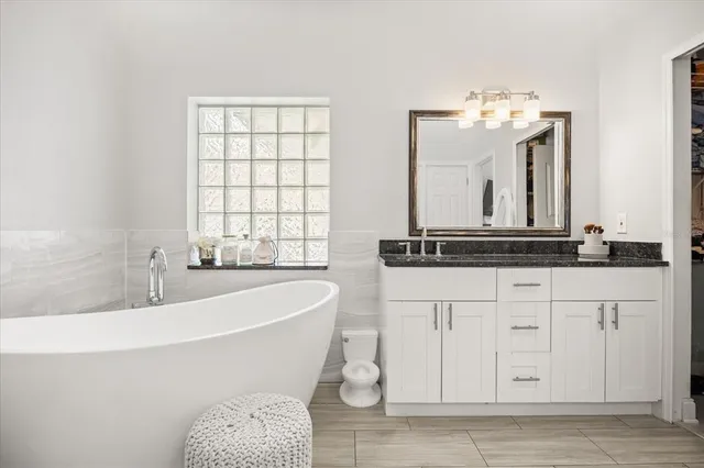 a bath room with a sink and a mirror
