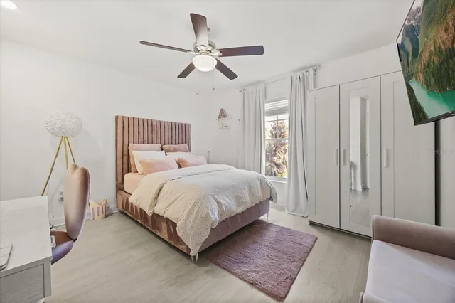a bedroom with a large bed and a chandelier