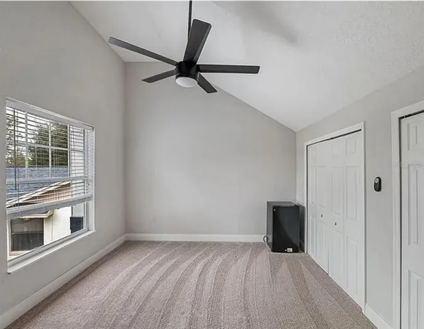 a view of a livingroom with a ceiling fan and window