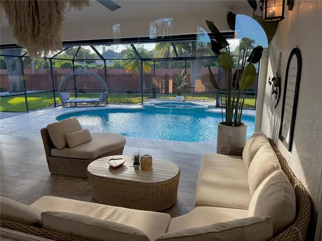 a living room with couches and a potted plant