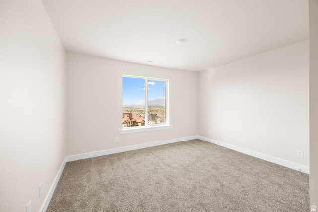 1510 West 600 North, Unit GE 04 Mapleton, UT 84664 - Photo 18 of 21 Bright interior space featuring a double-paned window, neutral carpet flooring, white baseboards, and a recessed ceiling light