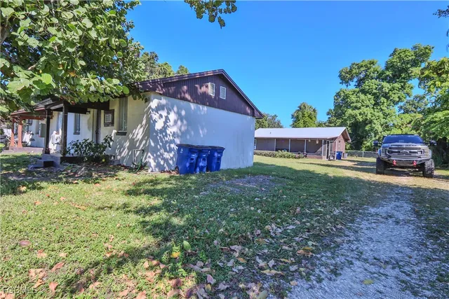 a front view of a house with a garden and yard