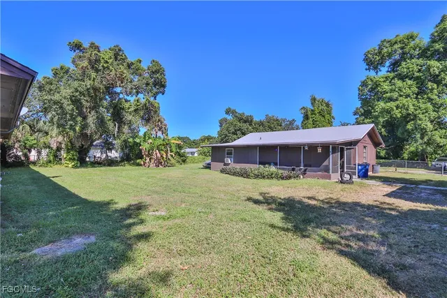 a view of street with houses and trees in the background