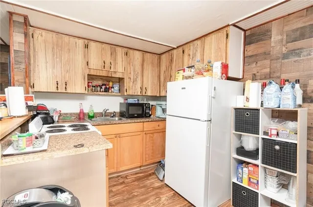 a kitchen with stainless steel appliances a refrigerator sink and cabinets