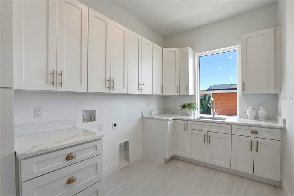 534 Crystal Drive Madeira Beach, FL 33708 - Photo 48 of 68 a kitchen with white cabinets and white appliances