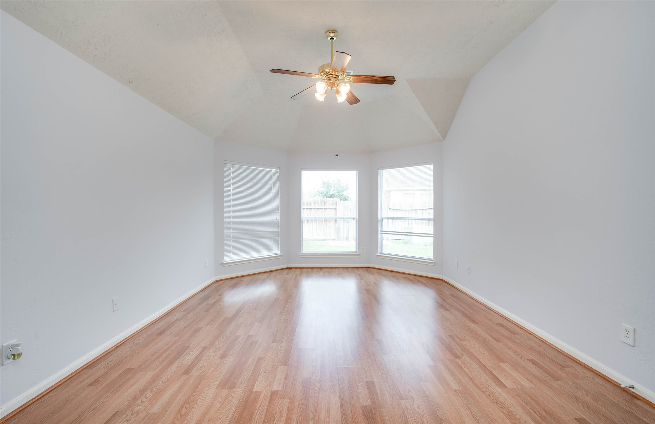 9323 Hillhaven Court Rosenberg, TX 77469 - Photo 22 of 37 a view of an empty room with wooden floor and a window