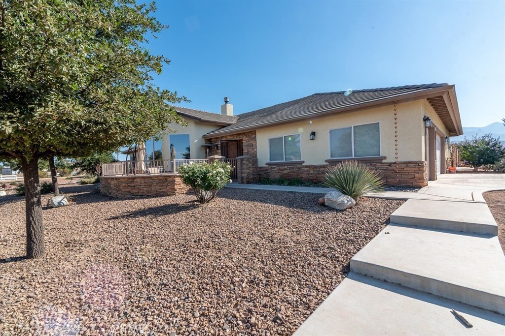 6997 Cygnet Road Phelan, CA 92371 - Photo 1 of 1 a front view of a house with garden