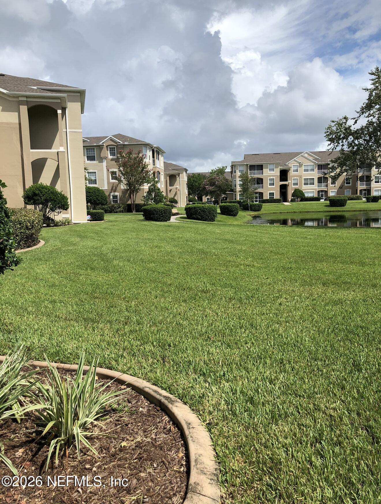 7990 Baymeadows Road, Unit 803 Jacksonville, FL 32256 - Photo 2 of 25 a front view of a house with a garden