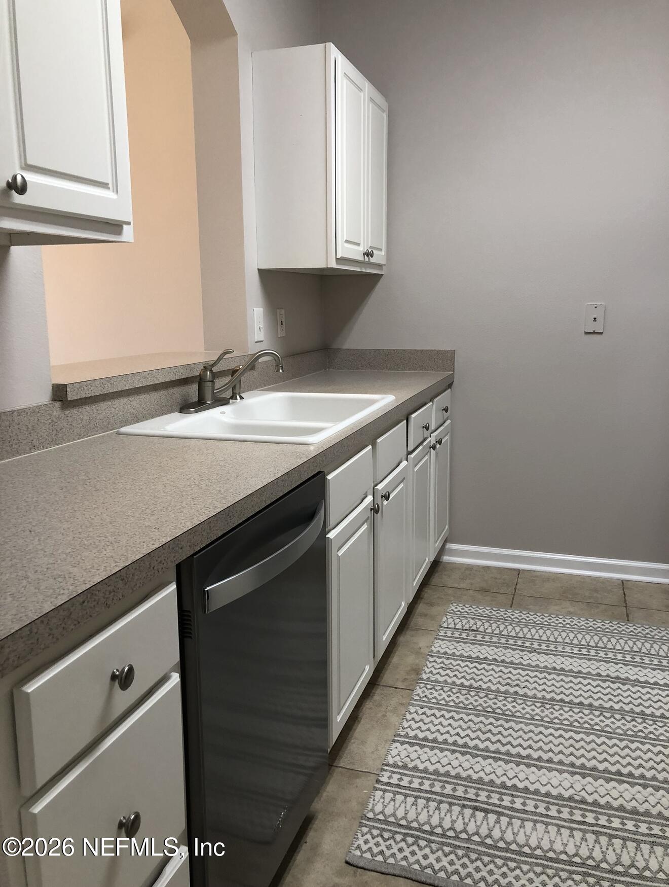 7990 Baymeadows Road, Unit 803 Jacksonville, FL 32256 - Photo 8 of 25 a kitchen with a sink and cabinets