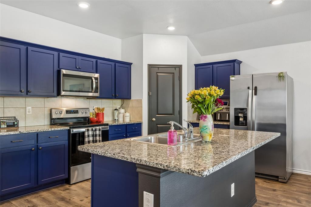 802 Rustic Way Royse City, TX 75189 - Photo 13 of 38 a kitchen with stainless steel appliances granite countertop a refrigerator a stove a sink a counter space and cabinets