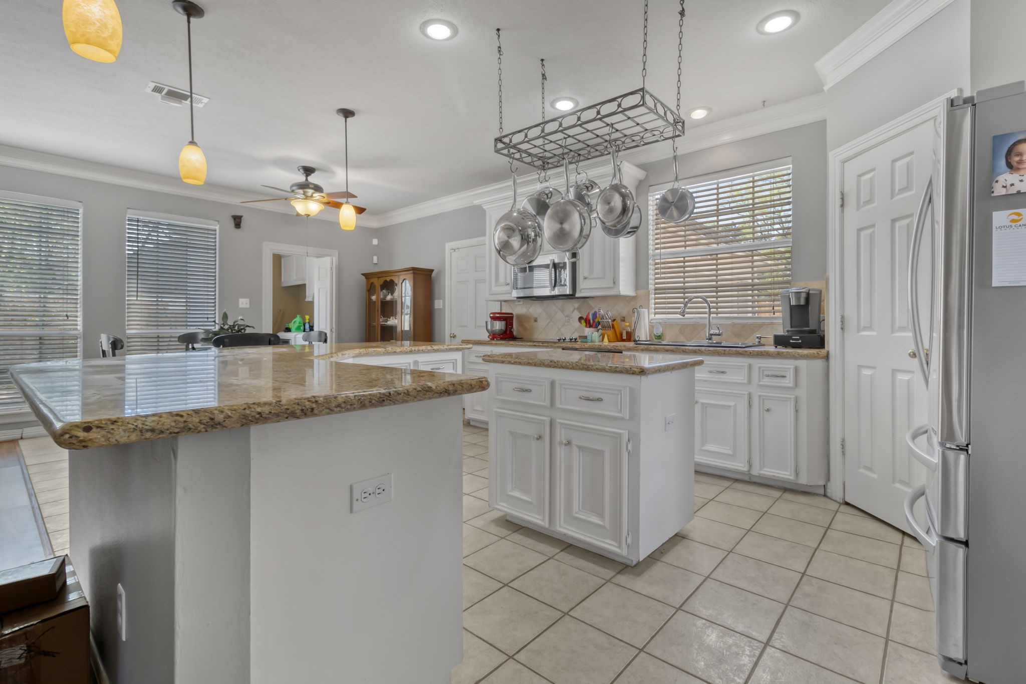 18106 Briden Oak Court Spring, TX 77379 - Photo 11 of 31 a large kitchen with cabinets and chairs