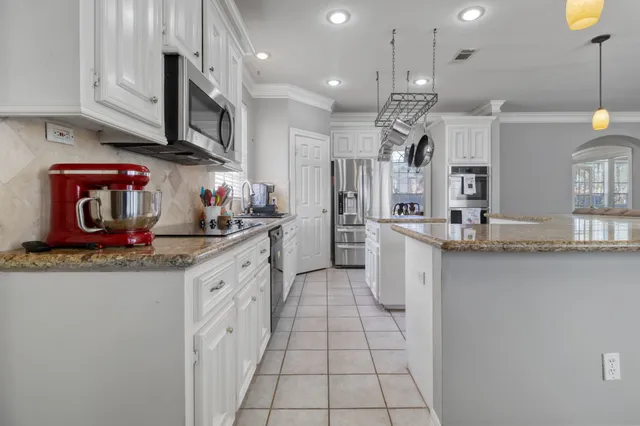 a kitchen with stainless steel appliances granite countertop a sink and cabinets