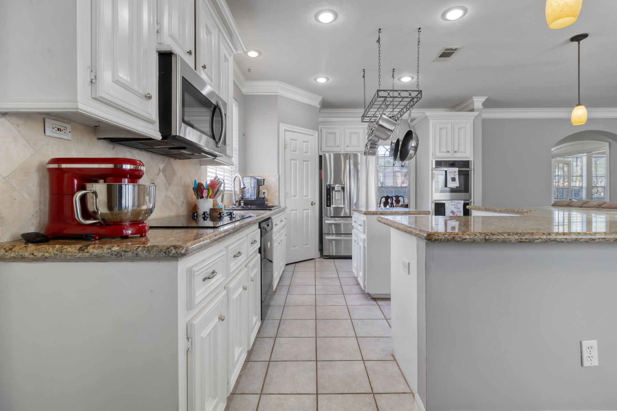 18106 Briden Oak Court Spring, TX 77379 - Photo 12 of 31 a kitchen with stainless steel appliances granite countertop a sink and cabinets