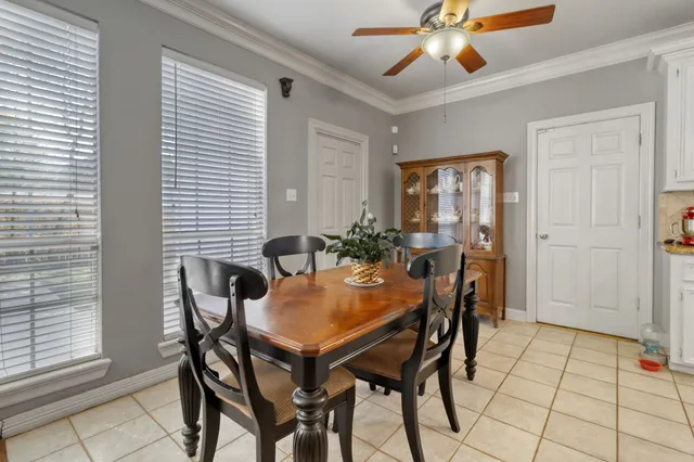 a view of a dining room with furniture and chandelier