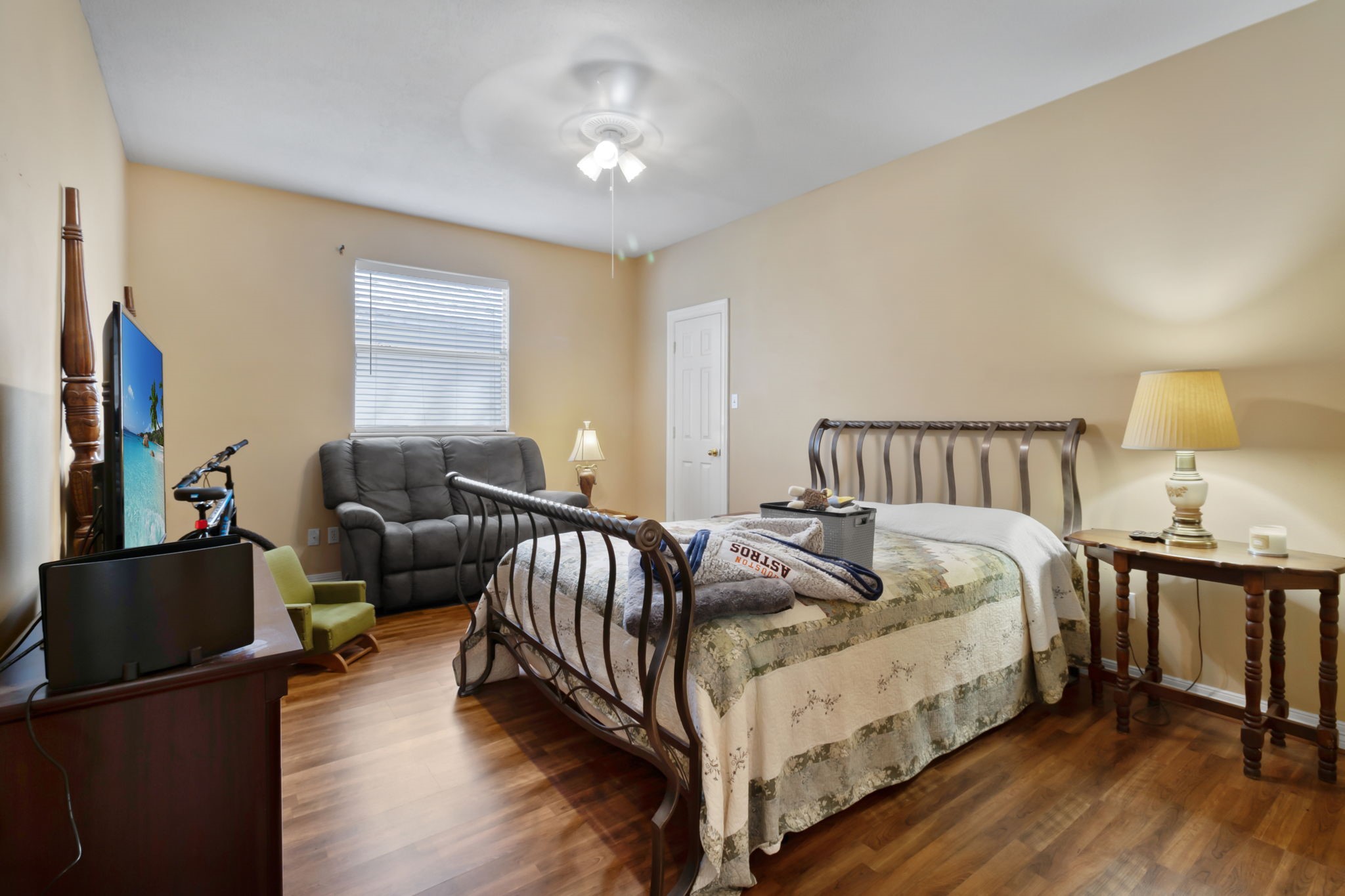 18106 Briden Oak Court Spring, TX 77379 - Photo 22 of 31 a bedroom with bed table and a couch