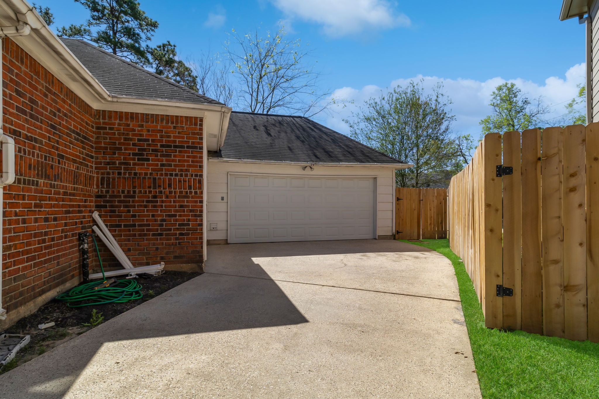 18106 Briden Oak Court Spring, TX 77379 - Photo 28 of 31 a view of entrance gate of house and wooden fence