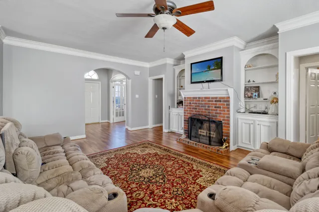 a living room with furniture a fireplace and a flat screen tv