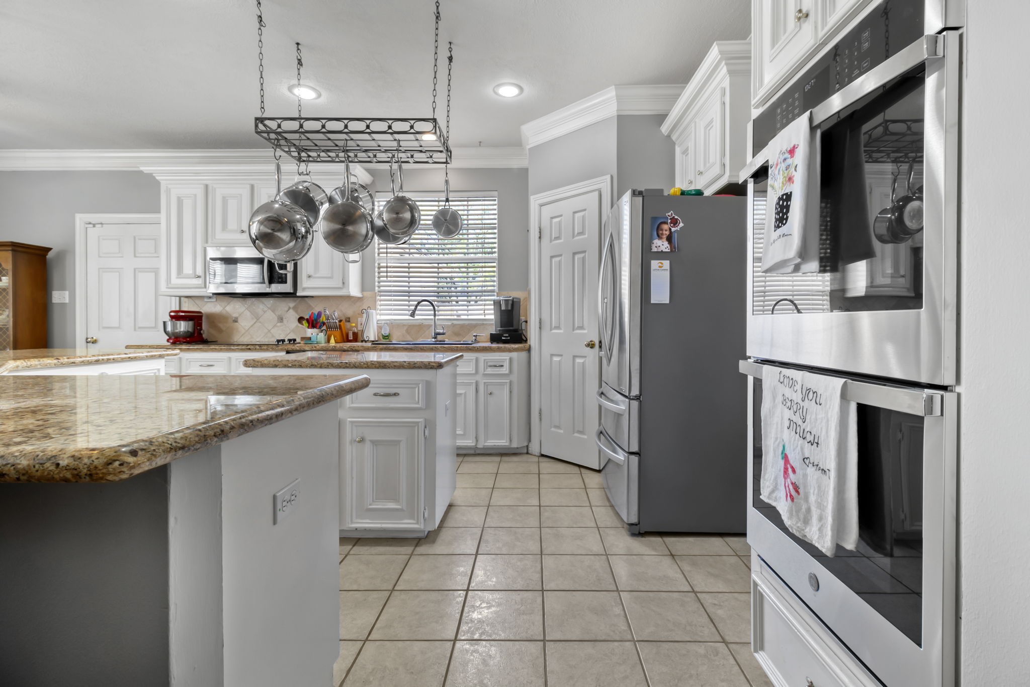 18106 Briden Oak Court Spring, TX 77379 - Photo 10 of 31 a kitchen with stainless steel appliances granite countertop a refrigerator a oven and a sink
