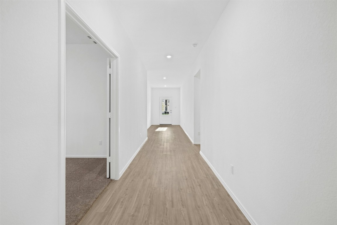 1804 Boggy Crk Rnch Road Georgetown, TX 78628 - Photo 17 of 28 a view of a hallway with wooden floor