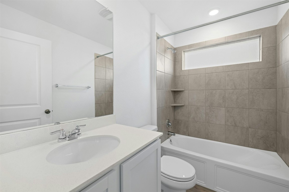 1804 Boggy Crk Rnch Road Georgetown, TX 78628 - Photo 22 of 28 a bathroom with a bathtub shower sink vanity mirror and toilet