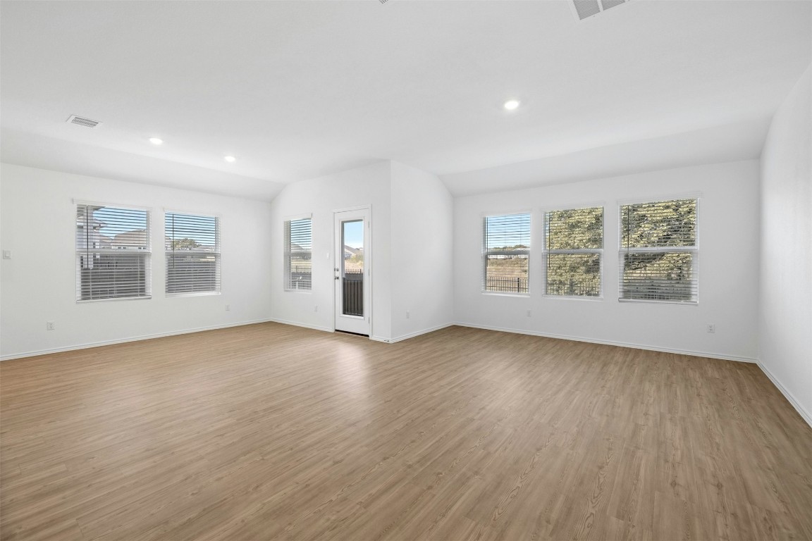 1804 Boggy Crk Rnch Road Georgetown, TX 78628 - Photo 5 of 28 an empty room with wooden floor and windows