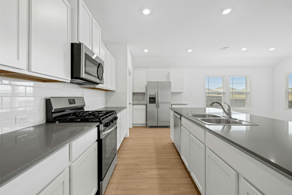1804 Boggy Crk Rnch Road Georgetown, TX 78628 - Photo 10 of 28 a kitchen with stainless steel appliances granite countertop a sink and stove top oven