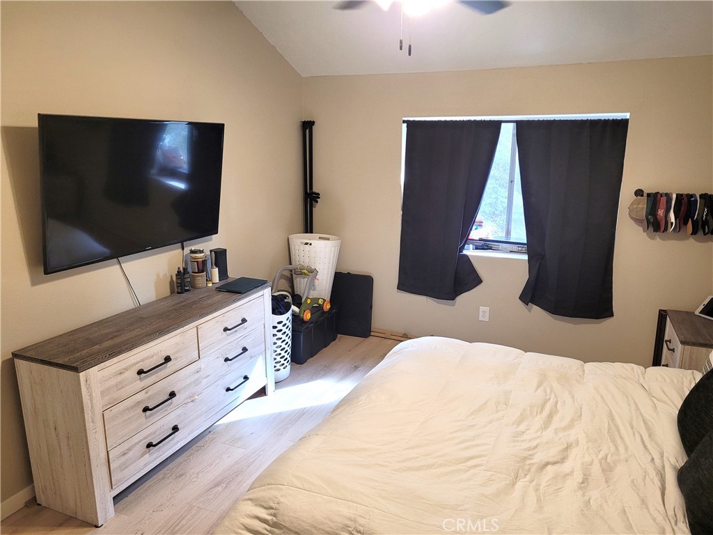 28162 Sloan Canyon Road, Unit A Castaic, CA 91384 - Photo 12 of 30 a bedroom with a bed and a flat screen tv