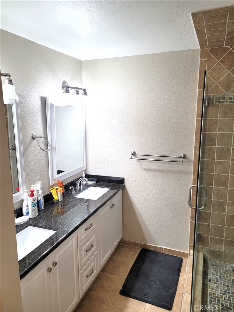 28162 Sloan Canyon Road, Unit A Castaic, CA 91384 - Photo 14 of 30 a bathroom with a sink and a mirror