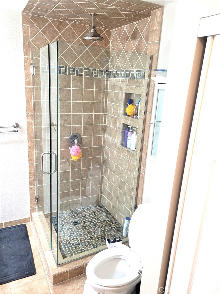 28162 Sloan Canyon Road, Unit A Castaic, CA 91384 - Photo 15 of 30 a bathroom with a toilet and shower