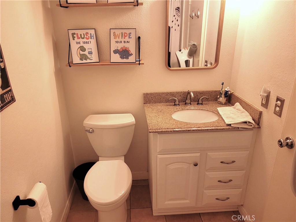 28162 Sloan Canyon Road, Unit A Castaic, CA 91384 - Photo 19 of 30 a bathroom with a toilet sink and mirror