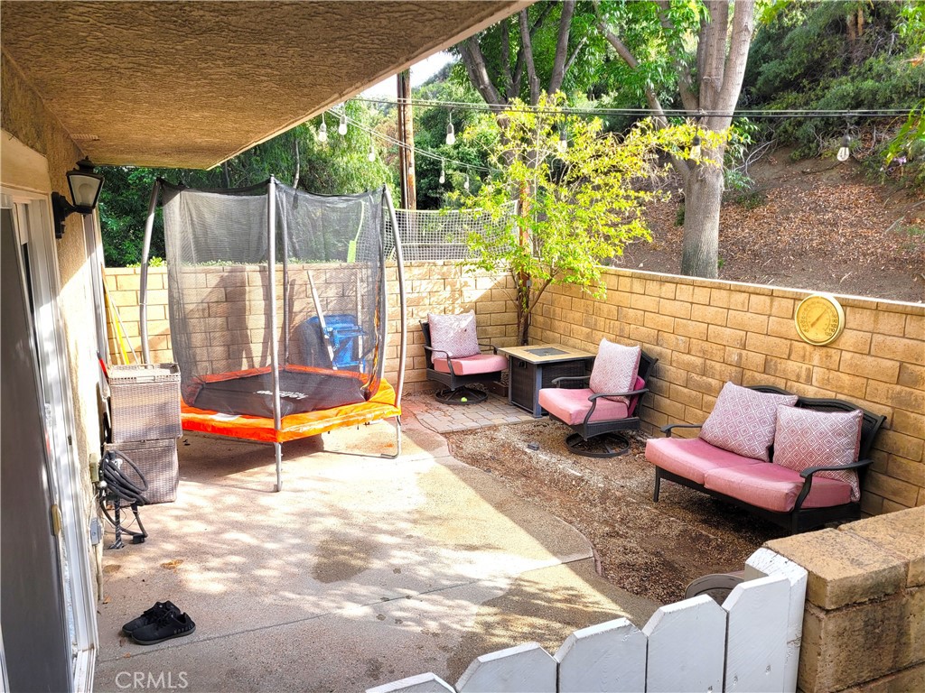 28162 Sloan Canyon Road, Unit A Castaic, CA 91384 - Photo 21 of 30 a outdoor space with patio the couch and dining table with garden view